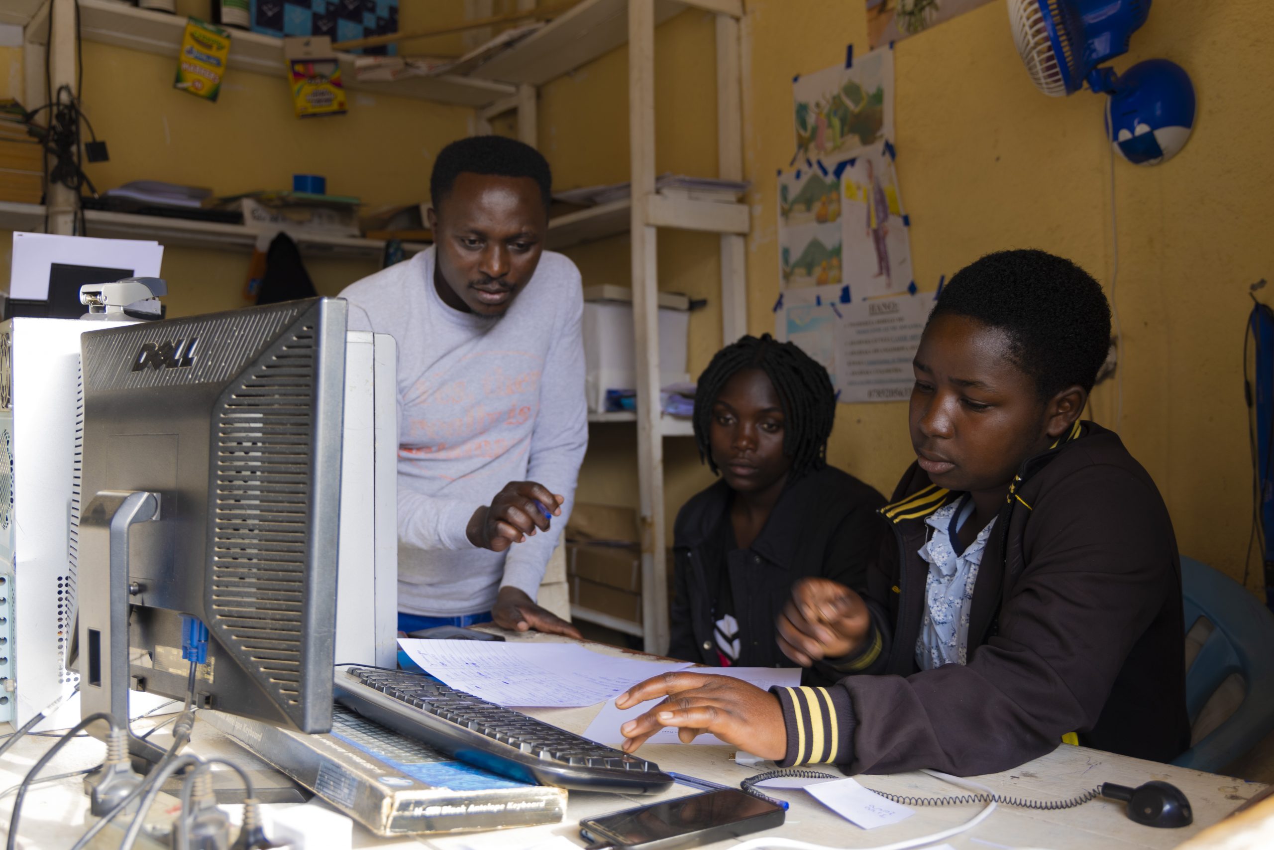 A student receives instruction on computer skills.