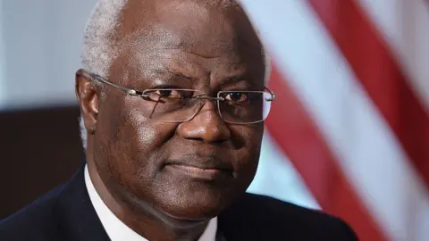 Getty Images A close-up shot of Ernest Bai Koroma's face. He wears glasses and a suit.