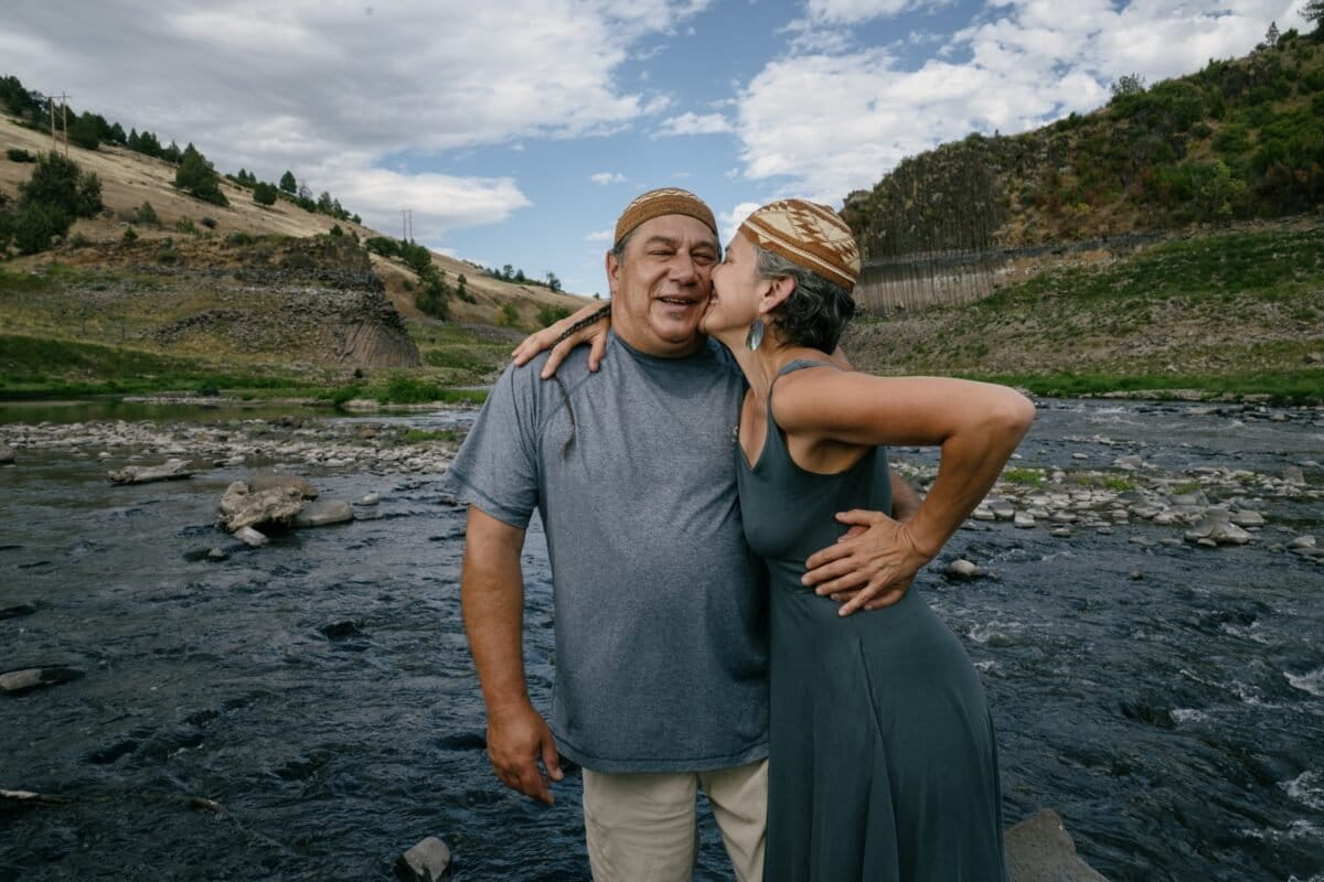 Lisa Morehead-Hillman and Leaf Hillman, both Karuk, celebrate the removal of the dams on the newly exposed reservoir floor in 2024. The former head of the Karuk Natural Resources Department, Leaf spent two decades working with other Indigenous groups, environmental organizations and government officials to bring back the Klamath River. Image courtesy of Kiliii Yüyan.