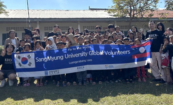 Sangmyung University students, participating in an international development cooperation program run in cooperation with Korea International Cooperation Agency, pose with local children in Luang Prabang, Laos, in this 2024 photo. Courtesy of Sangmyung University